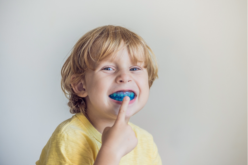 A child with a mouthguard in their mouth