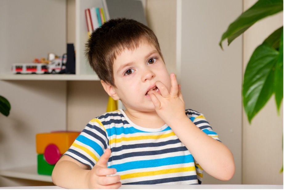 A child chewing on his nails