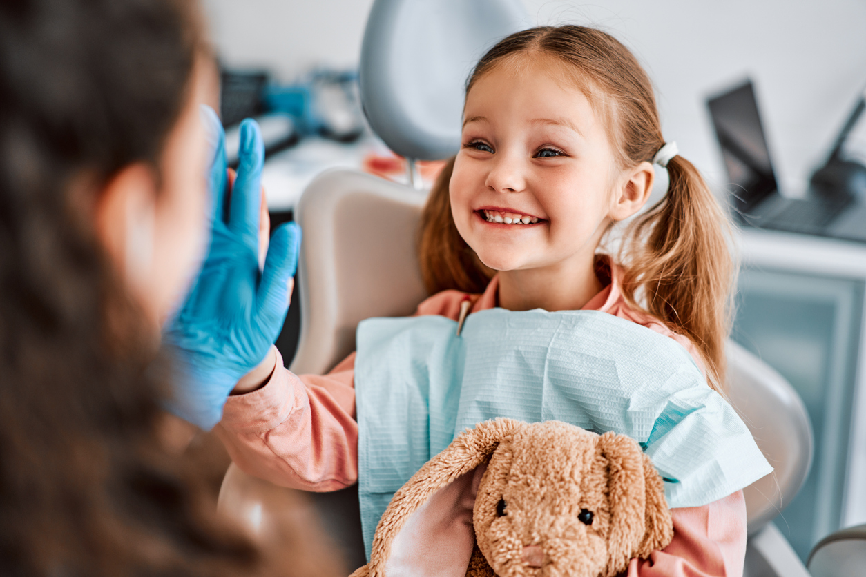 child at dentist office smiling, high five, Innovative Technology at Orem Pediatric Dentistry for Children's Dental Anesthesia